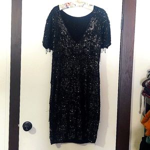Black Beaded and Sequin Dress Size 12-14 as it is stretchable and form fitting.